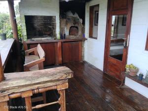 a porch of a house with a wooden table and an oven at Dali in La Pedrera +24 photos