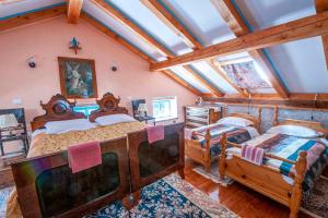 a bedroom with two beds and a ceiling with beams at Pri Macku in Tolmin +52 photos