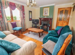 a living room with a couch and a fireplace at Levally hs mountrivers doonbeg co clare in Kilrush