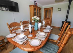 a dining room table with white dishes on it at Levally hs mountrivers doonbeg co clare in Kilrush
