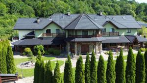 a large house with a lot of trees in front of it at Zielona Przystań - Noclegi in Maków Podhalański +29 photos