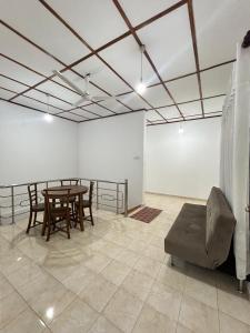 a room with a table and chairs and a couch at Lion Isle Residence in Anuradhapura +21 photos