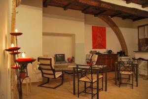 a dining room with a table with chairs and a computer at La Casa Di Tufo in Orvieto
