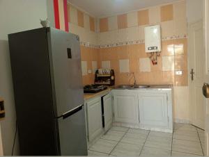 a kitchen with a refrigerator and a sink at Dar Khuwayra in El Haouaria