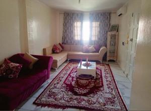 a living room with a couch and a table at Dar Khuwayra in El Haouaria