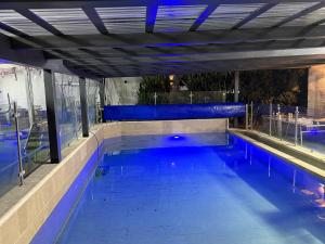a large swimming pool with blue water at אחוזת רוממה - Villa Romema in Safed