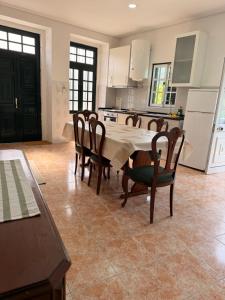 a kitchen and dining room with a table and chairs at Casa Misarela in Ruivãis +7 photos