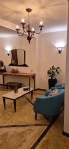 a living room with a blue couch and a table at Solar Itacaré - Charme e aconchego. in Itacaré +53 photos