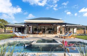 a house with a patio and a swimming pool at Ka'ana Resort & Spa in San Ignacio