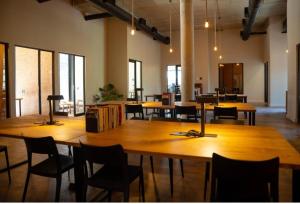 a large room with tables and chairs and windows at BlackBrick2 in Johannesburg