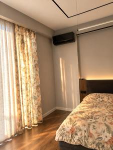 a bedroom with a bed and a large window at Cozy family apartment at Seabreeze Nardaran, Beach & Pool, Polo Residence in Baku
