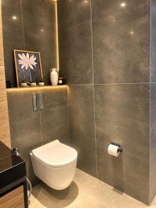 a bathroom with a toilet and a wall at Cozy family apartment at Seabreeze Nardaran, Beach & Pool, Polo Residence in Baku +1 photo