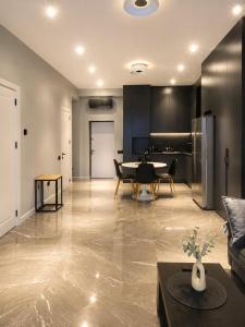 a living room with a table and a dining room at Cozy family apartment at Seabreeze Nardaran, Beach & Pool, Polo Residence in Baku