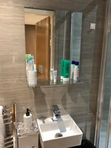 a bathroom with a sink and a mirror at The Anfield Apartment in Liverpool +72 photos