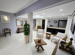 a living room with a couch and a table at Hotel Colonial in Pôrto Ferreira