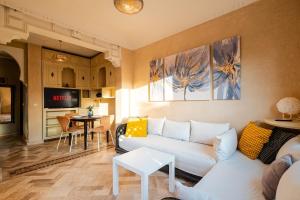 a living room with a couch and a table at Atlas Golf Resort in Marrakesh