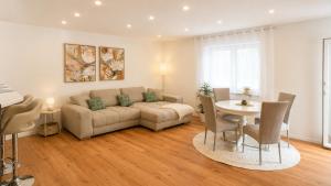 a living room with a couch and a table at Ferienwohnung Bayer in Gründau