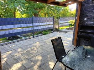 a patio with a bench and a fence at Graphite Residence Chynowo in Chynowo