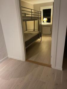 a hallway with two bunk beds in a room at Ocean view Villa Säby Tjörn in Säby