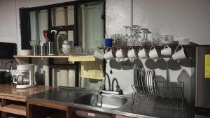 a kitchen with a sink and utensils on a wall at Casa Vista Cafe in Cartago