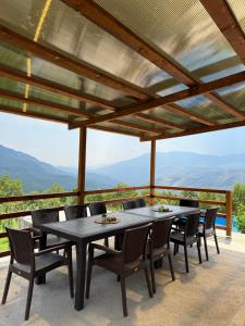 a table and chairs on a patio with a view at House Tickon Ostrog in Trubasinj