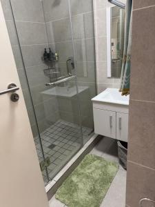 a bathroom with a shower with a sink and a toilet at Studio Luxe The Aura Your Calm Escape in Northriding +7 photos