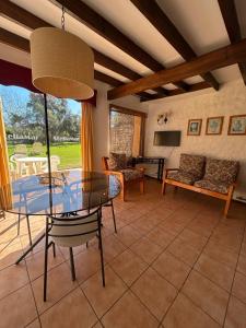 a dining room with a glass table and chairs at Stellamar Apart Hotel in La Serena