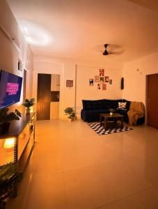 a living room with a couch and a table at Eden Stay in Siliguri