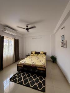 a bedroom with a bed in the middle of a room at Eden Stay in Siliguri +11 photos