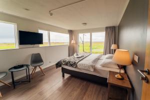a bedroom with a large bed and a window at Farmhouse in Vík
