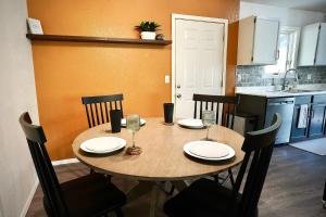 a kitchen with a wooden table with chairs and a dining room at Pet-Family-Friendly Duplex with Parking in Wasilla