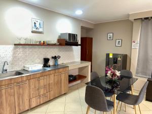 a kitchen with a table with chairs and a counter top at Apartamentos - Torre de Cali in Cali