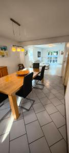 a dining room with a wooden table and chairs at FeWo Altstadt Herrieden in Herrieden