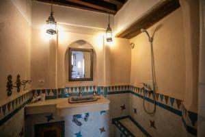 a bathroom with a sink and a shower with a mirror at Dar Ras Jnan -luxury stay - rooftop in Oulad Akkou +19 photos