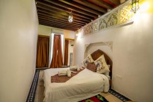 a bedroom with a large bed in a room at Dar Ras Jnan -luxury stay - rooftop in Oulad Akkou