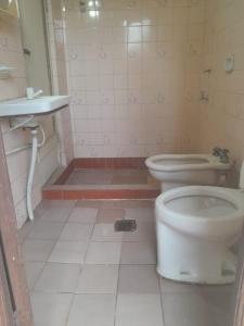 a bathroom with a toilet and a sink at Tata Róga in Asunción