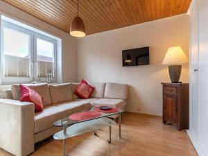 a living room with a couch and a table at Ferienhaus in Tönning in Tönning