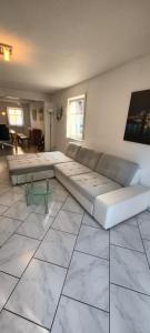 a living room with a large couch and a table at FeWo Altstadt Herrieden in Herrieden