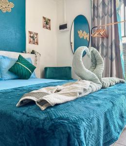 a bed with two swans on top of it at L'échappée verte in Chirongui