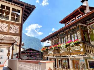 a building with flowers on the balconies on a street at Garnì Stella Alpina in Canazei