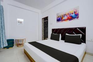 a bedroom with a large bed in a room at Hotel O City Star in Rewa