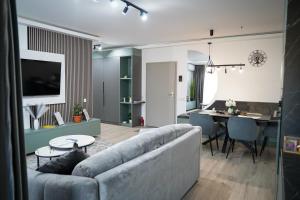 a living room with a couch and a dining room at Stay Unique in Râşnov