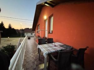 a table and chairs on the balcony of a house at Sanlej Apartman in Tuzla