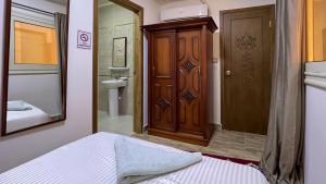 a bedroom with a door and a bed and a bathroom at Atlantis Pyramids Inn in Giza +133 photos