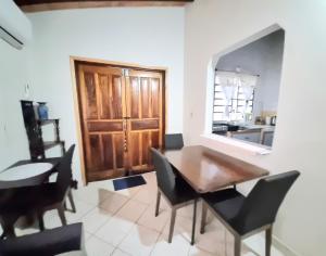 a dining room with a table and chairs and a kitchen at Departamento Batti in Asunción +8 photos