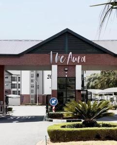 a building with a sign that reads the aula at Studio Luxe The Aura Your Calm Escape in Northriding