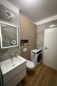 a bathroom with a sink and a toilet and a microwave at Stay Unique in Râşnov +38 photos