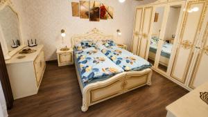 a bedroom with a bed and a sink and a mirror at Vidiecky dom Leles in Leles
