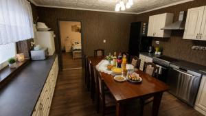 a kitchen with a table with food and drinks on it at Vidiecky dom Leles in Leles +34 photos