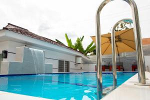 a swimming pool in front of a house at Modern Studio with Swimming Pool in Njiro, Arusha in Arusha